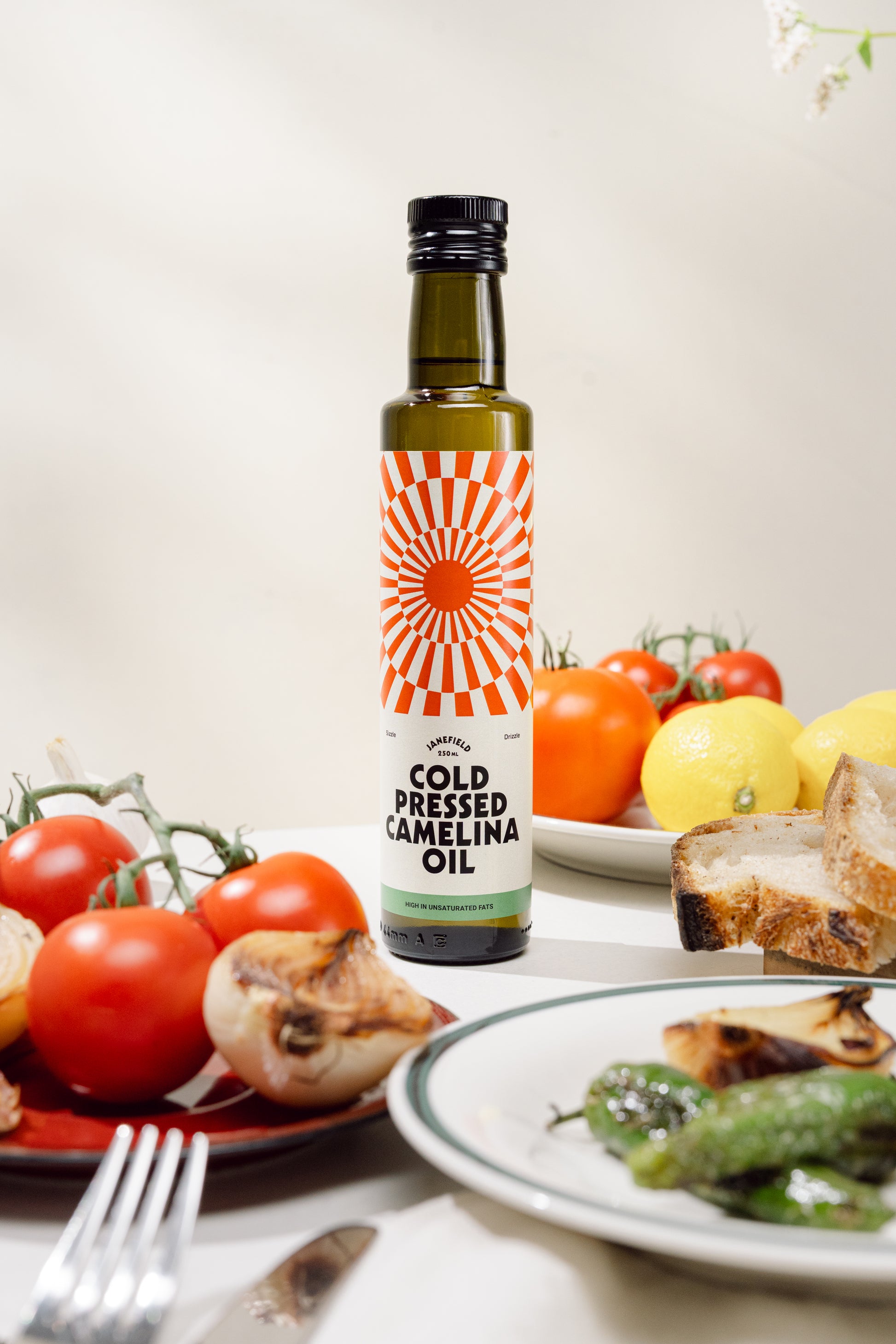 Cold pressed camelina oil bottle on table with healthy food