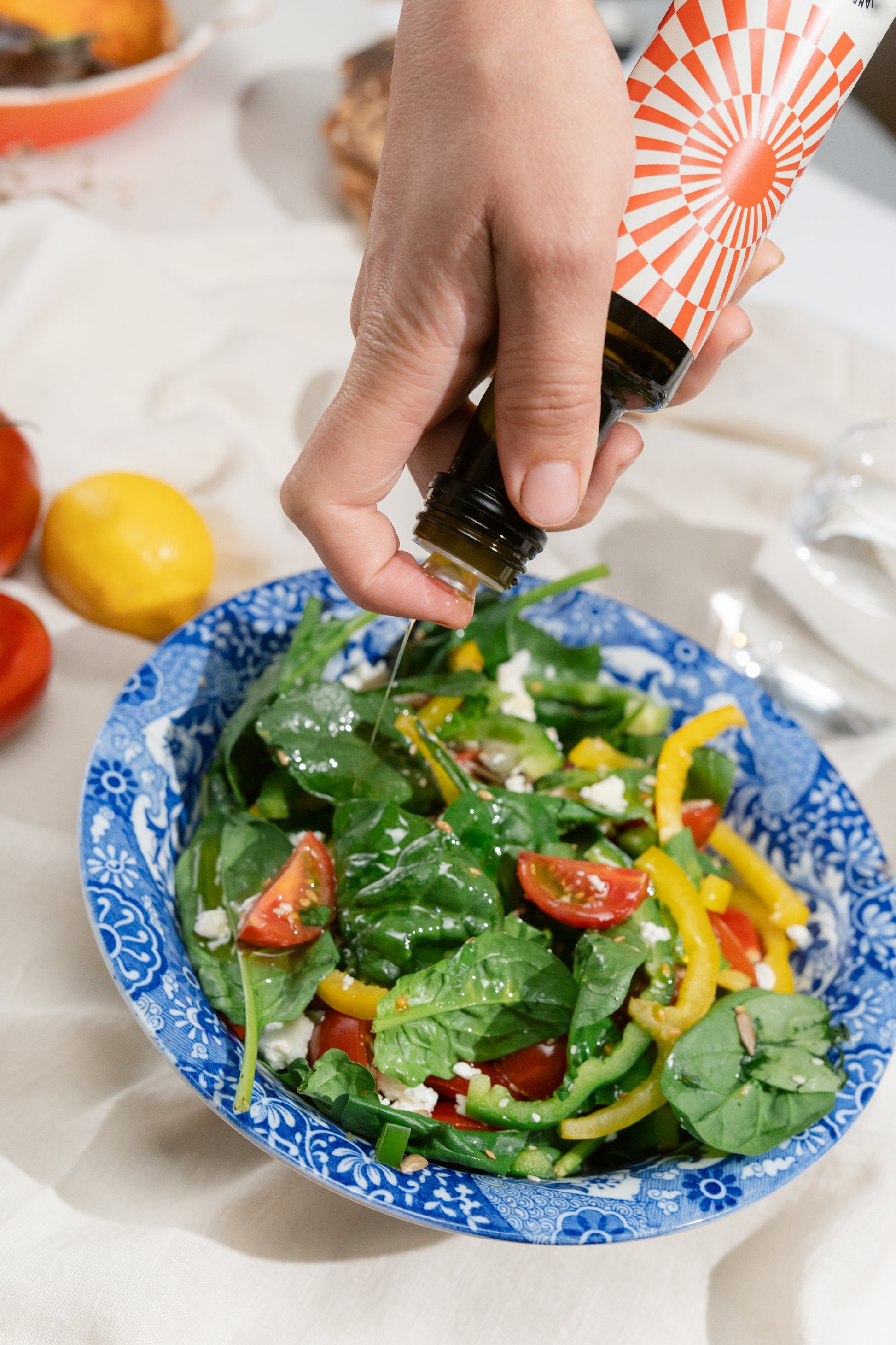 Camelina oil being drizzled on fresh salad.